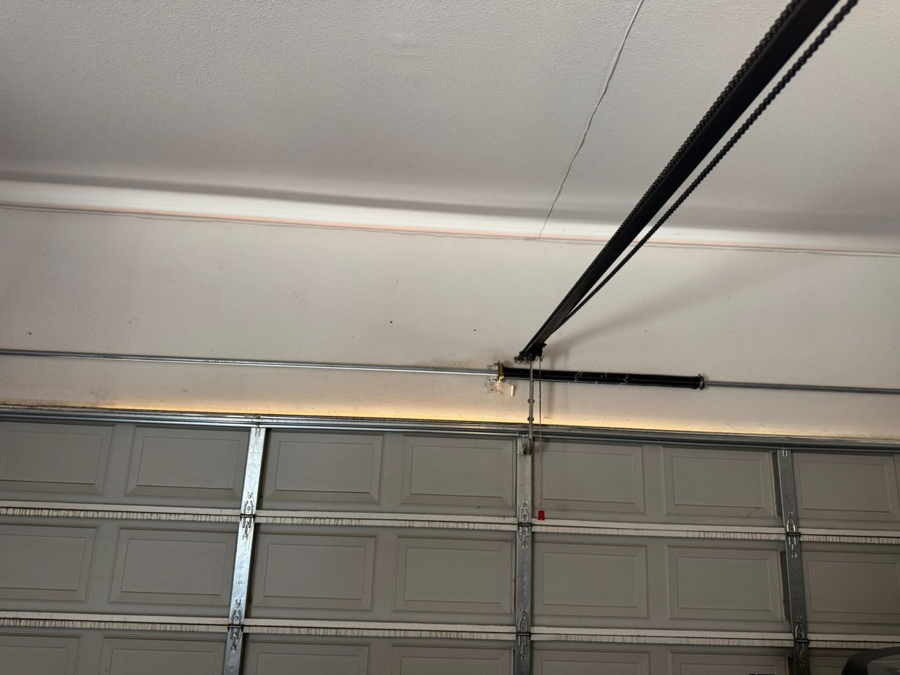 Newly wound torsion spring on the shaft above a residential garage door